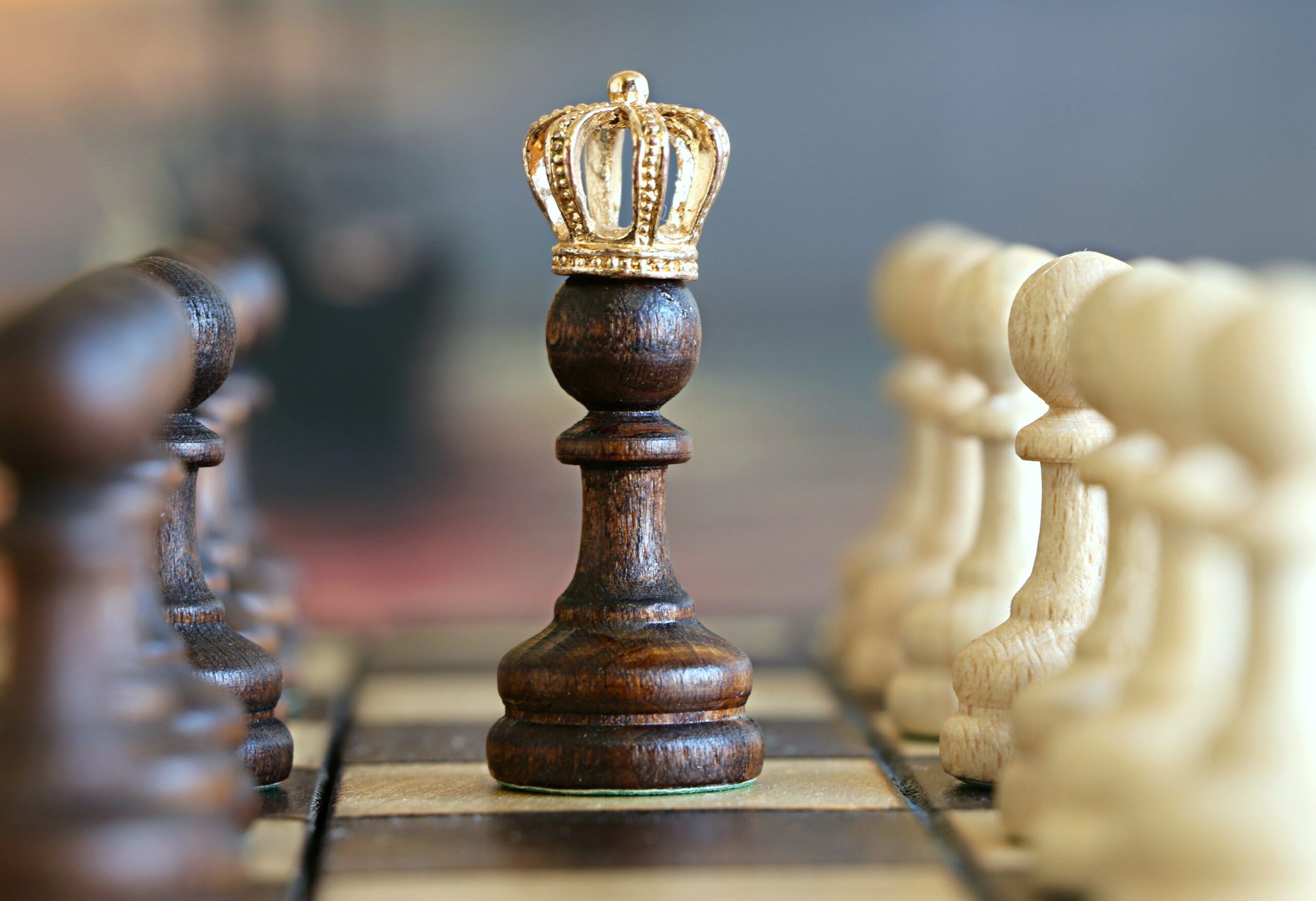 Image of Pawn on chessboard with a crown.